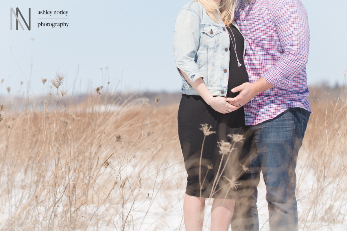 husband and wife at maternity session outside in winter