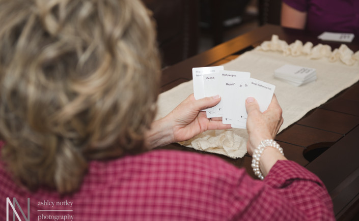 bridesmaids playing cards against humanity during getting ready photos