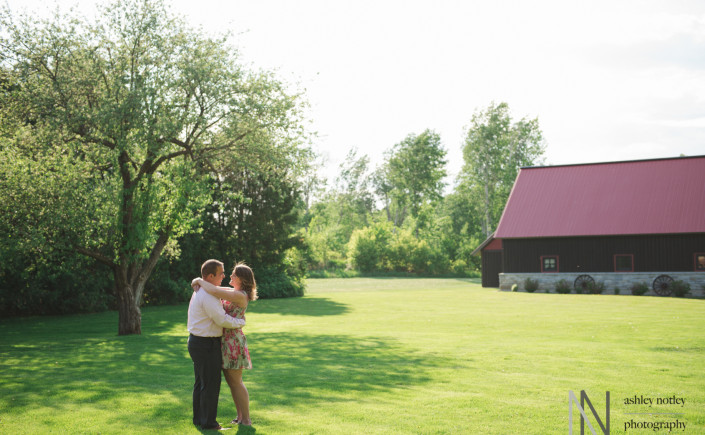 Couple underneath a tree with barn in the background