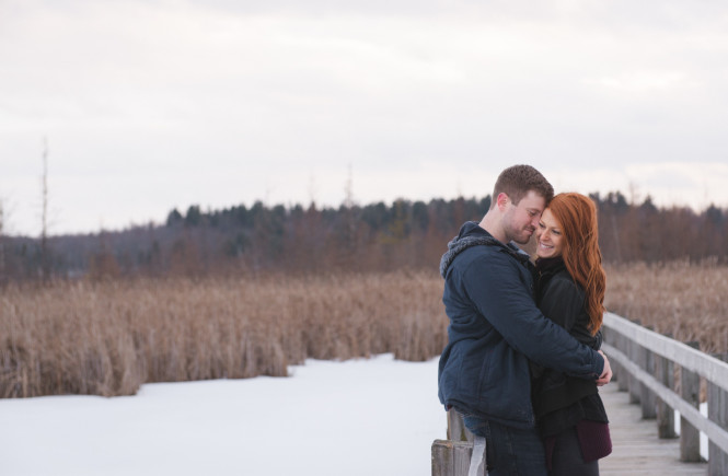 Couple cuddling at the bridge at mer bleue bog