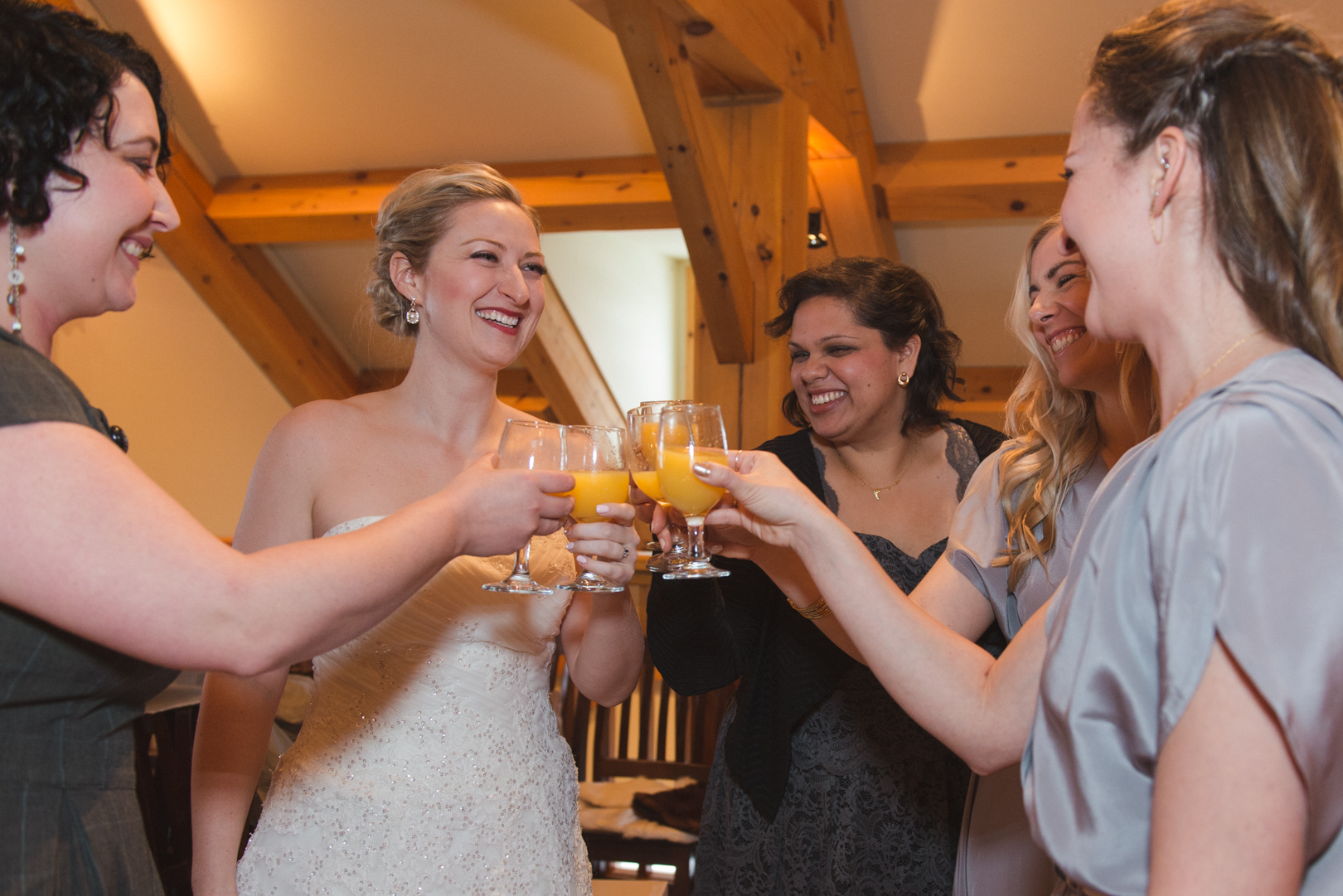 Bride and bridesmaids cheersing before wedding ceremony