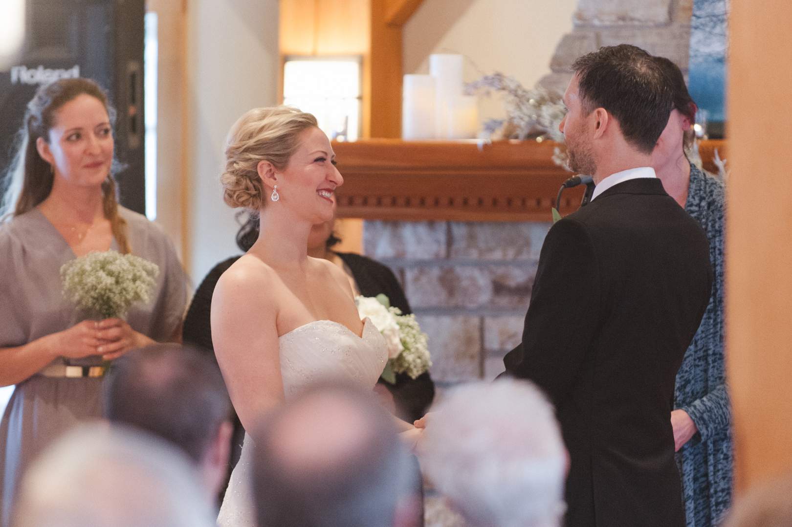 Bride smiling at her groom during wedding ceremony