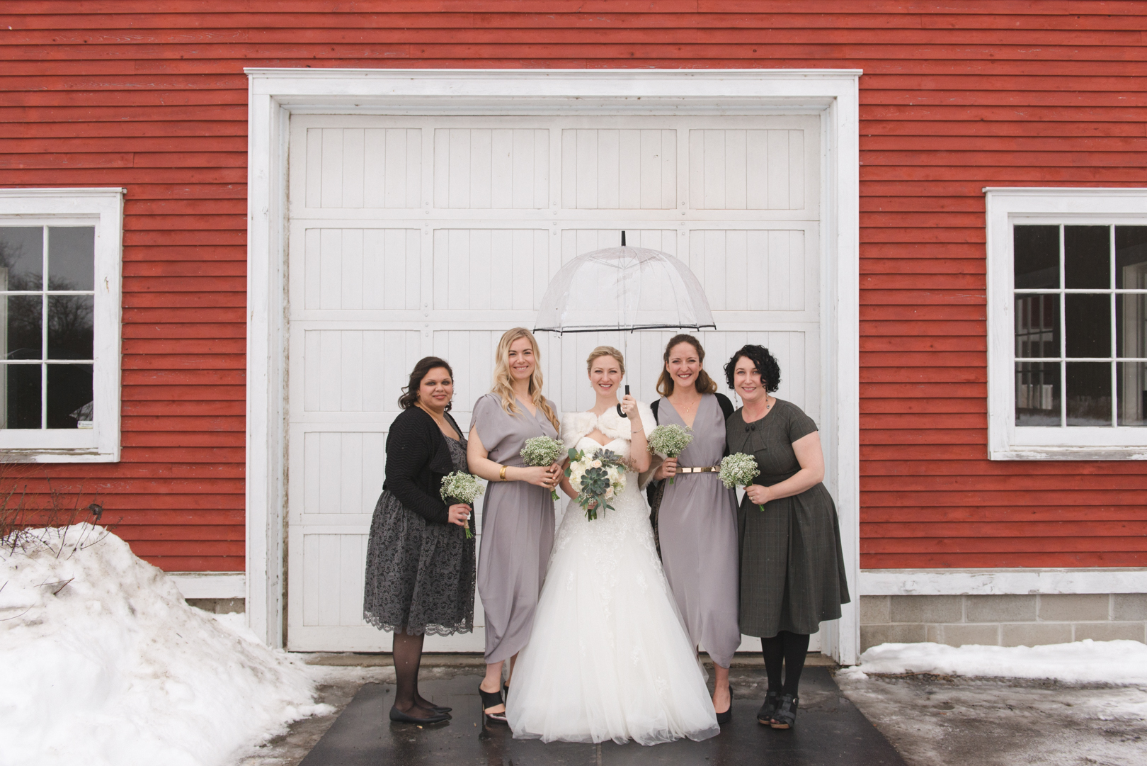 Bride and bridesmaids with umbrella at Temples Sugar Bush