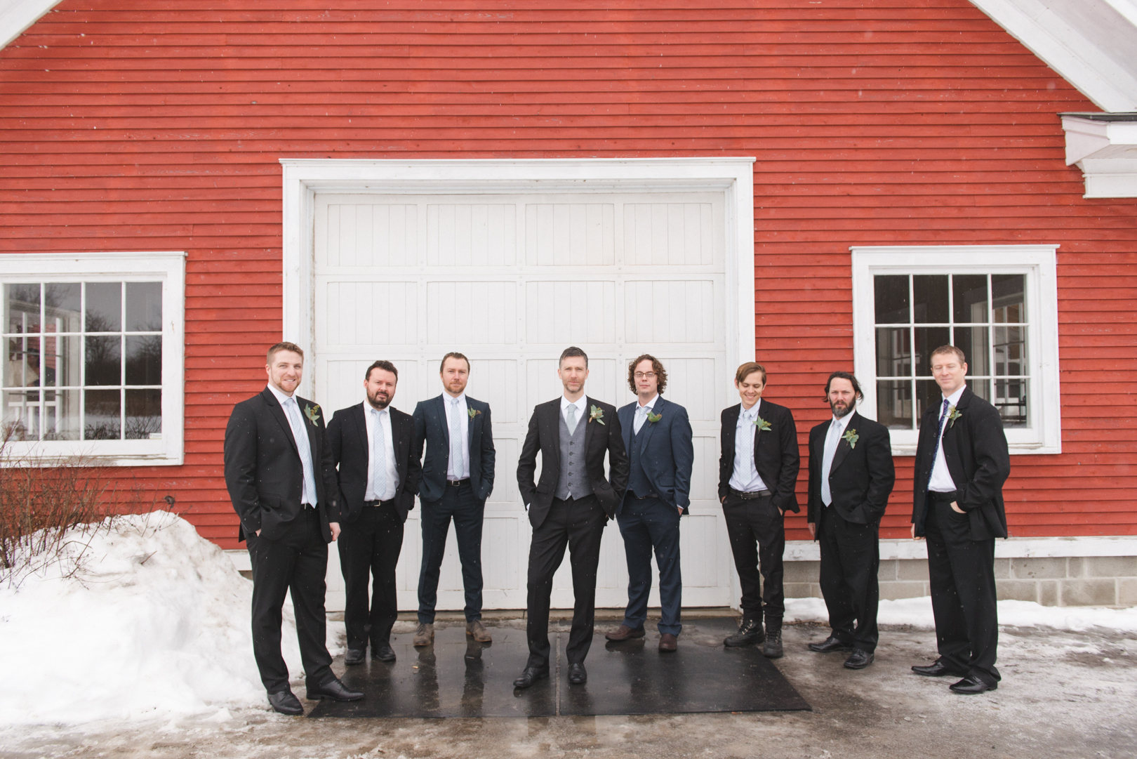 Groomsmen in front of white door at Temples Sugar Bush