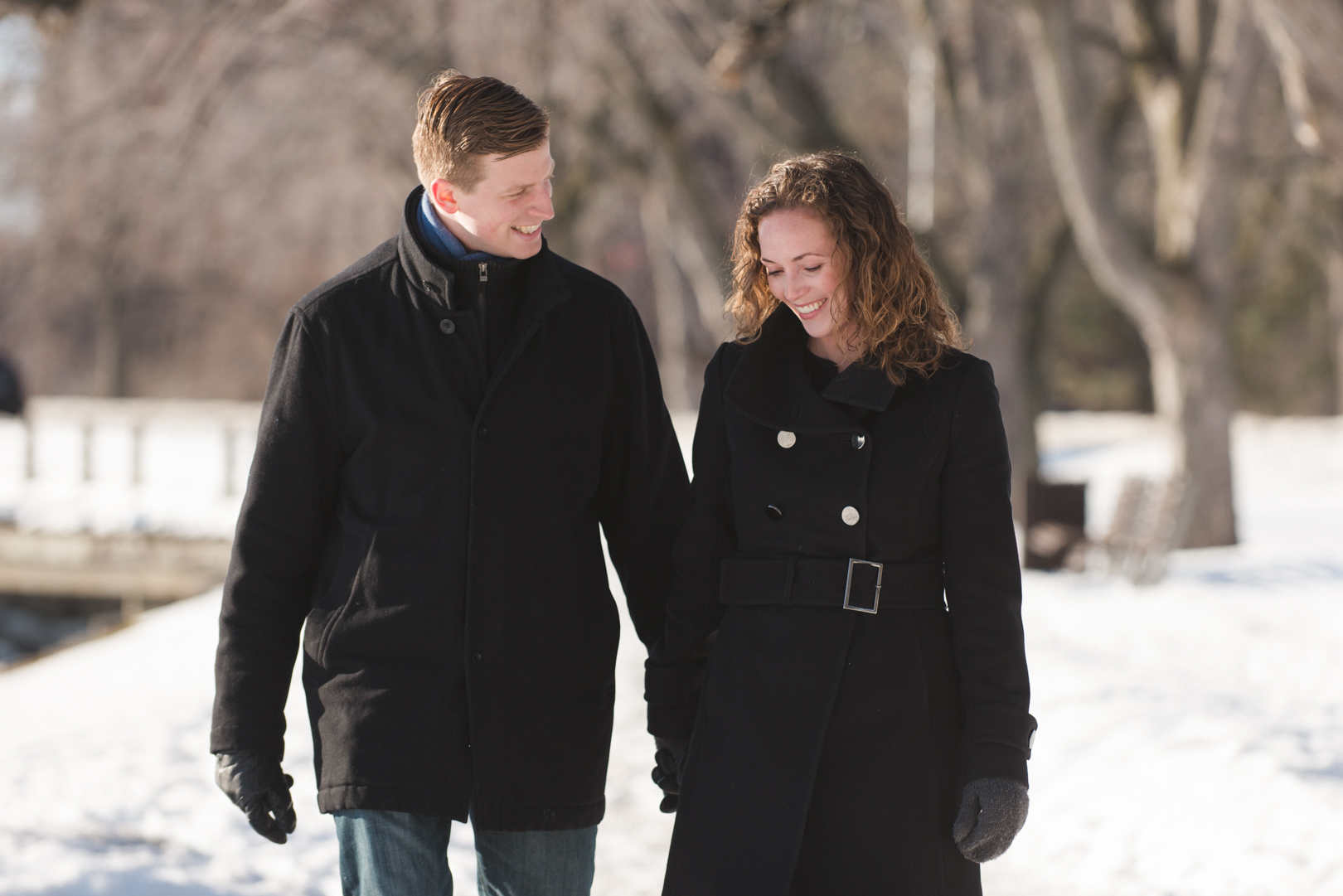 couple walking along a snow covered path in Ottawa
