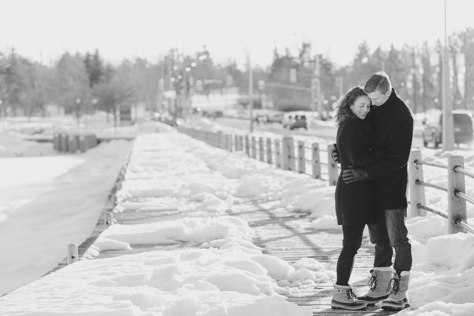 Couple standing on wooden boardwalk in the snow