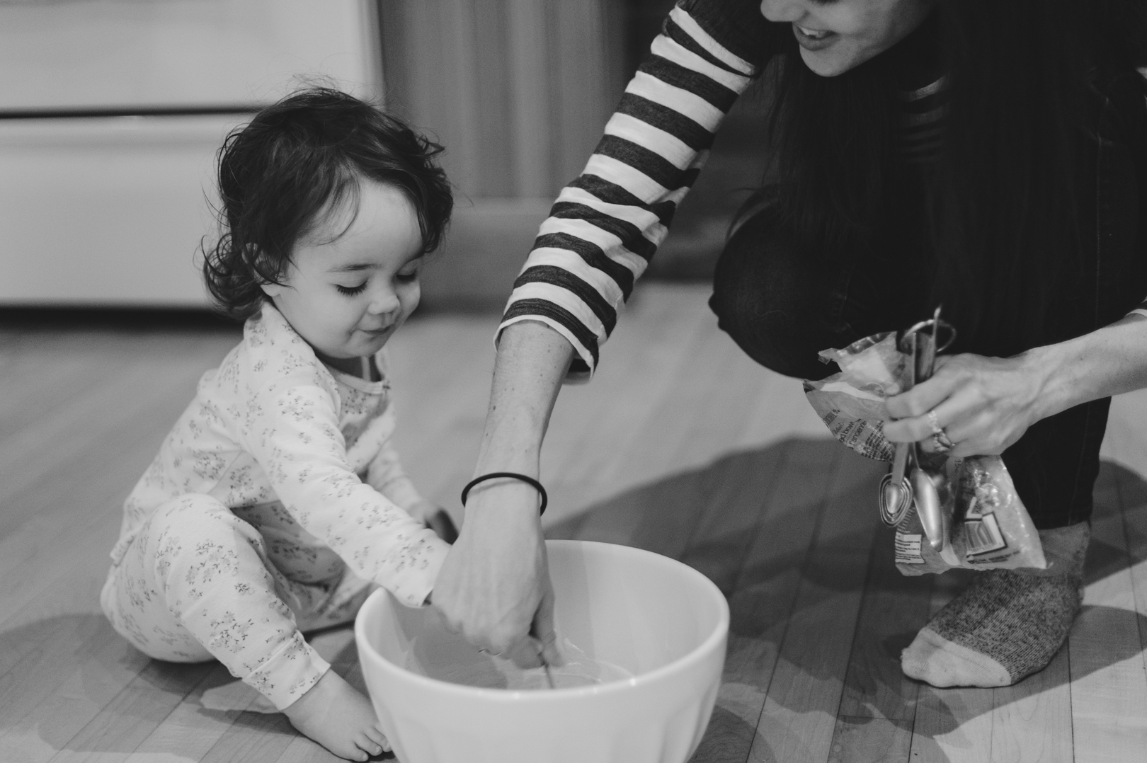 Little girl helping mom make pancakes on a Saturday morning in Ottawa. Photo by Ashley Notley Photography.
