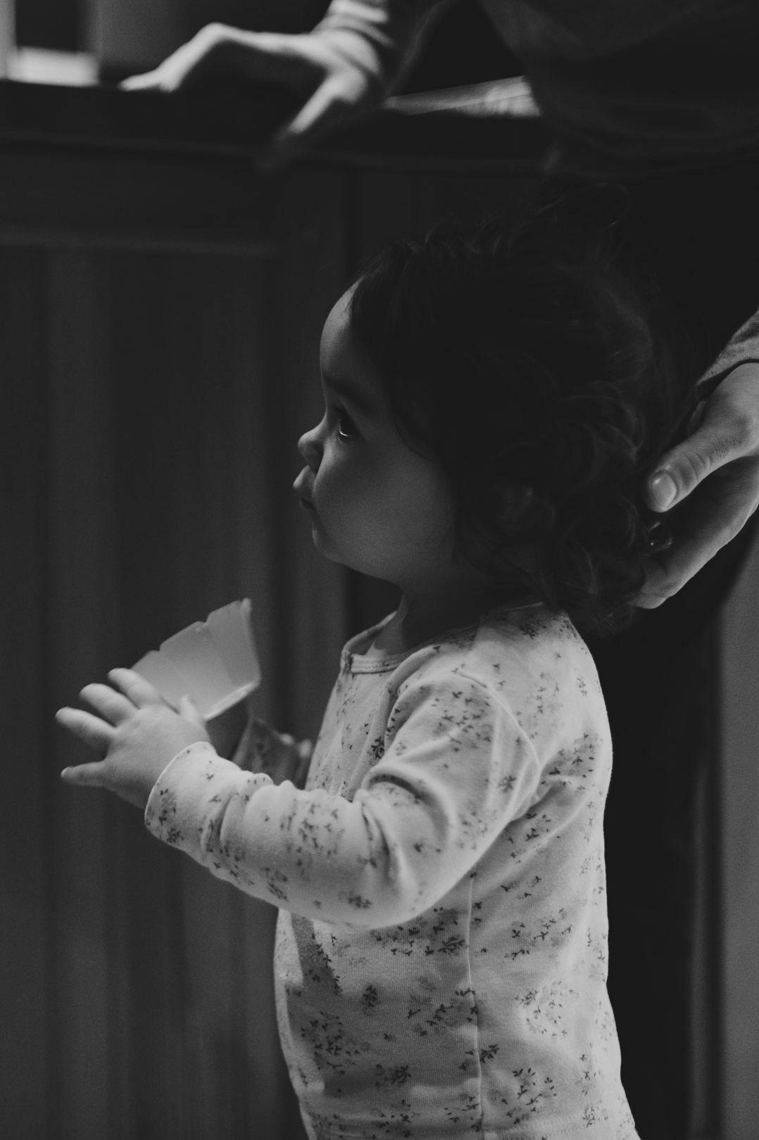 Little girl waiting for mom to make her pancakes on a Saturday morning. Photo by Ashley Notley Photography.