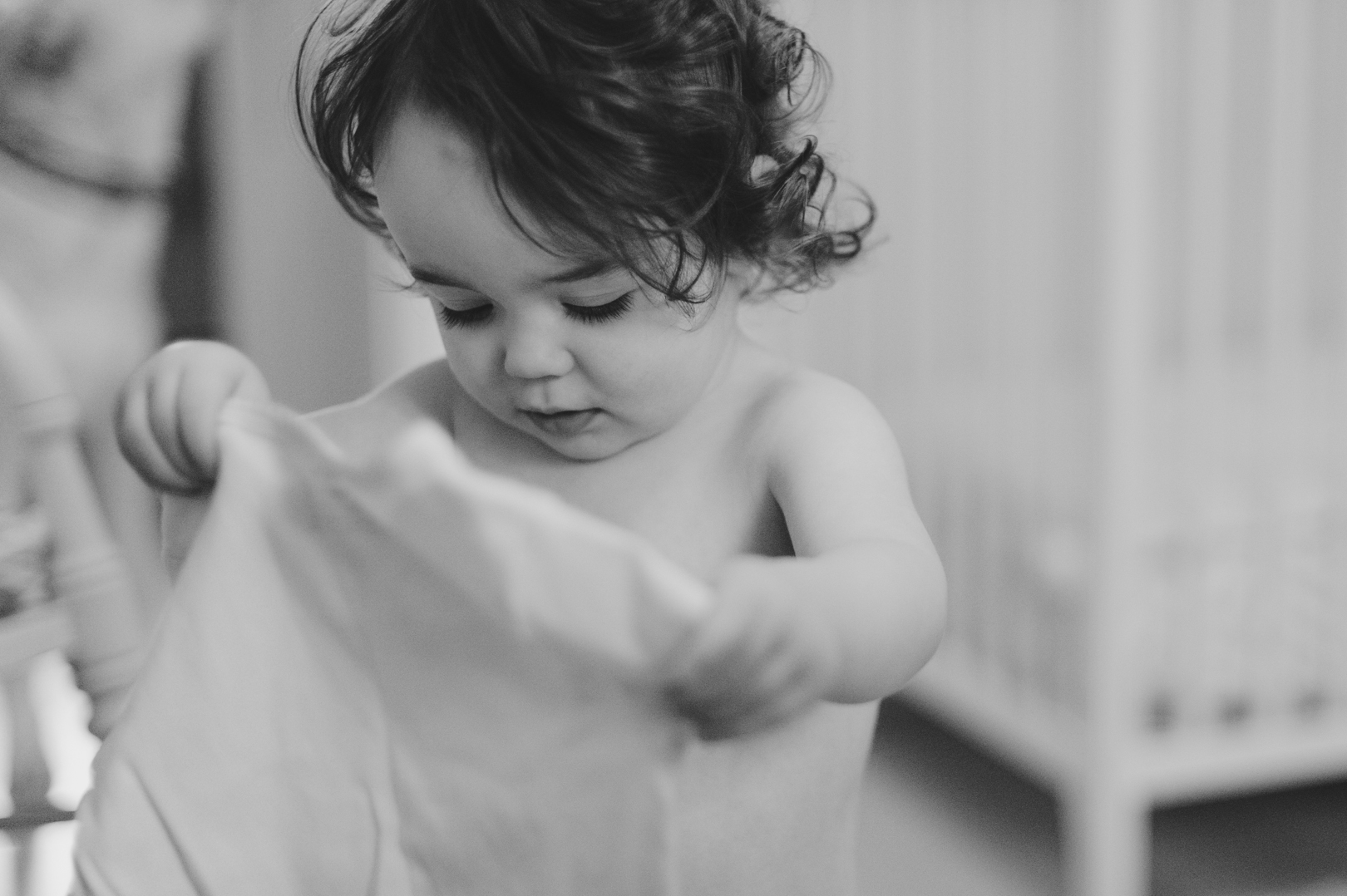 Little girl picking out her shirt while getting dressed on Saturday morning. Photo by Ashley Notley Photography.