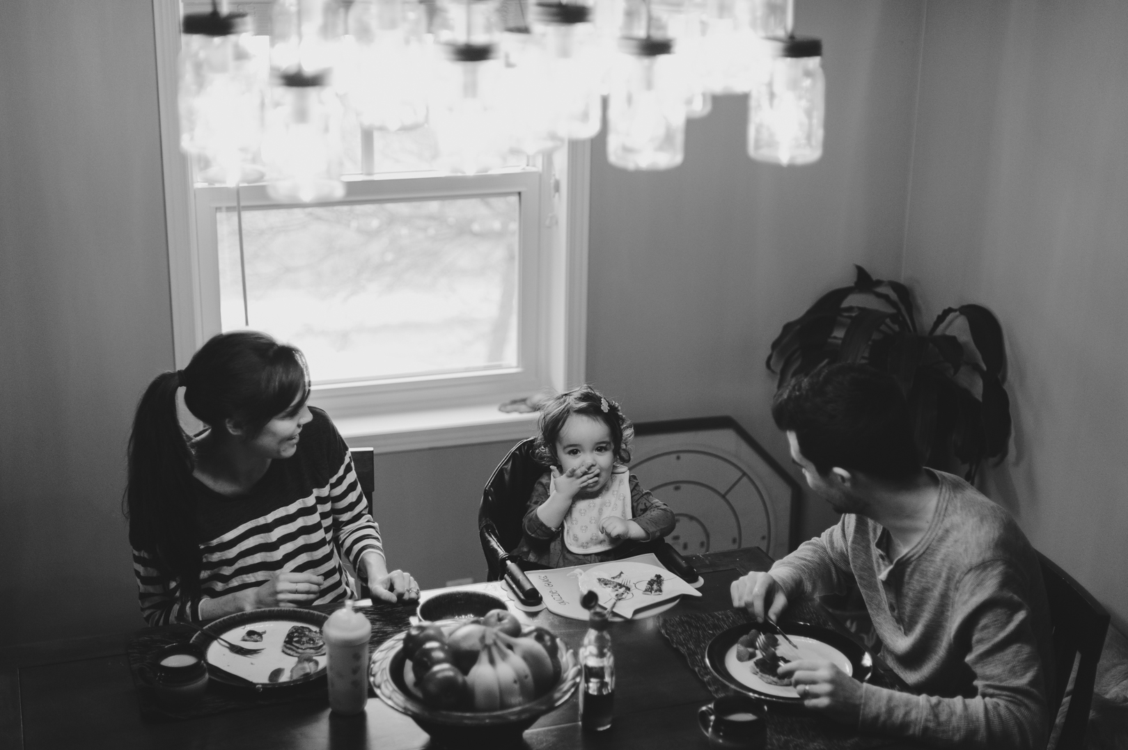Family eating pancake breakfasttogether at the table on Saturday morning. Dad and daughter playing together on Saturday morning. Photo by Ashley Notley Photography.