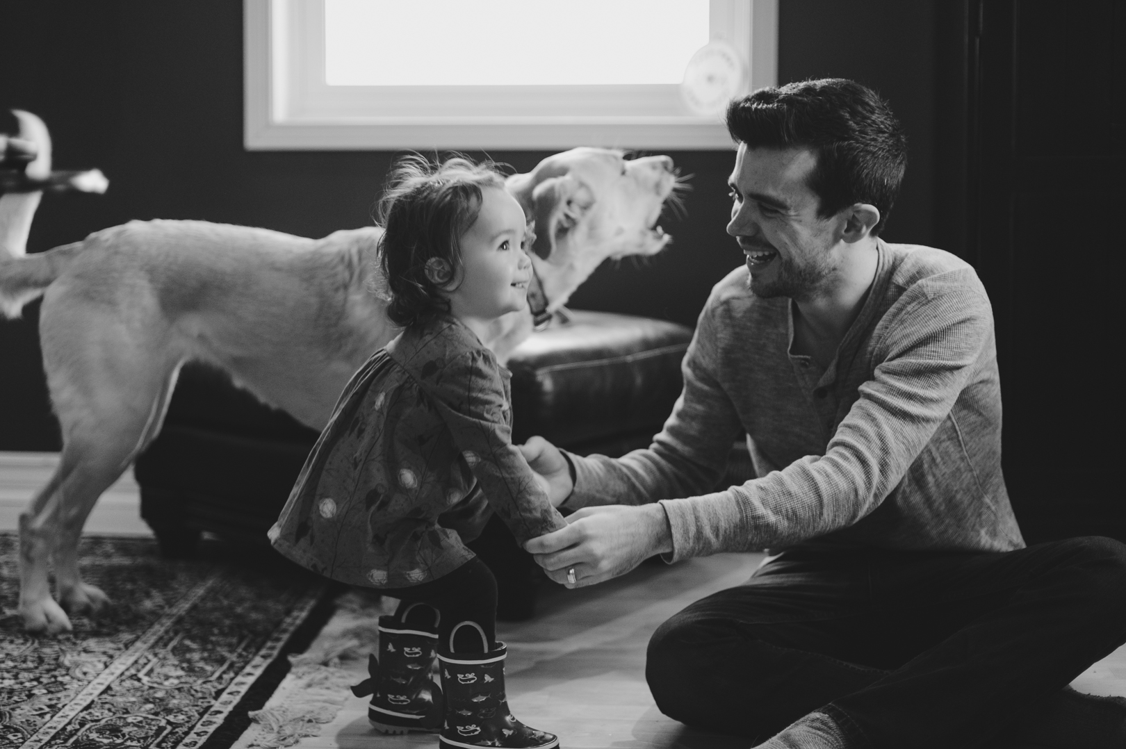 dad and daughter laughing together on Saturday morning. Dad and daughter playing together on Saturday morning. Photo by Ashley Notley Photography.