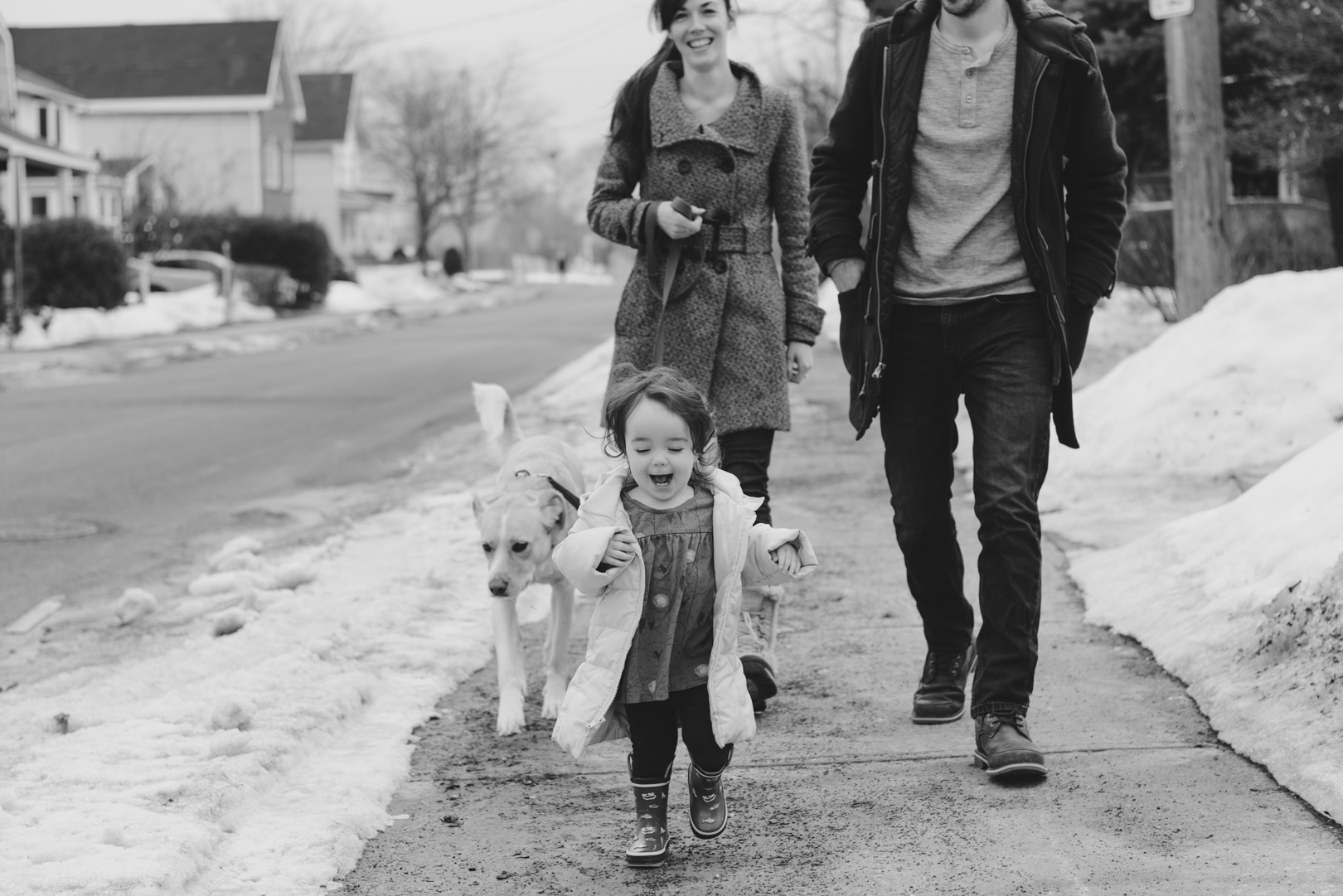 Family taking dog for a walk outside on Saturday morning. Dad and daughter playing together on Saturday morning. Photo by Ashley Notley Photography.