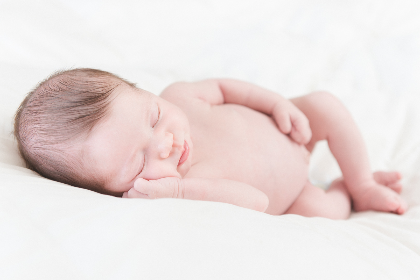 nude baby girl on a white background