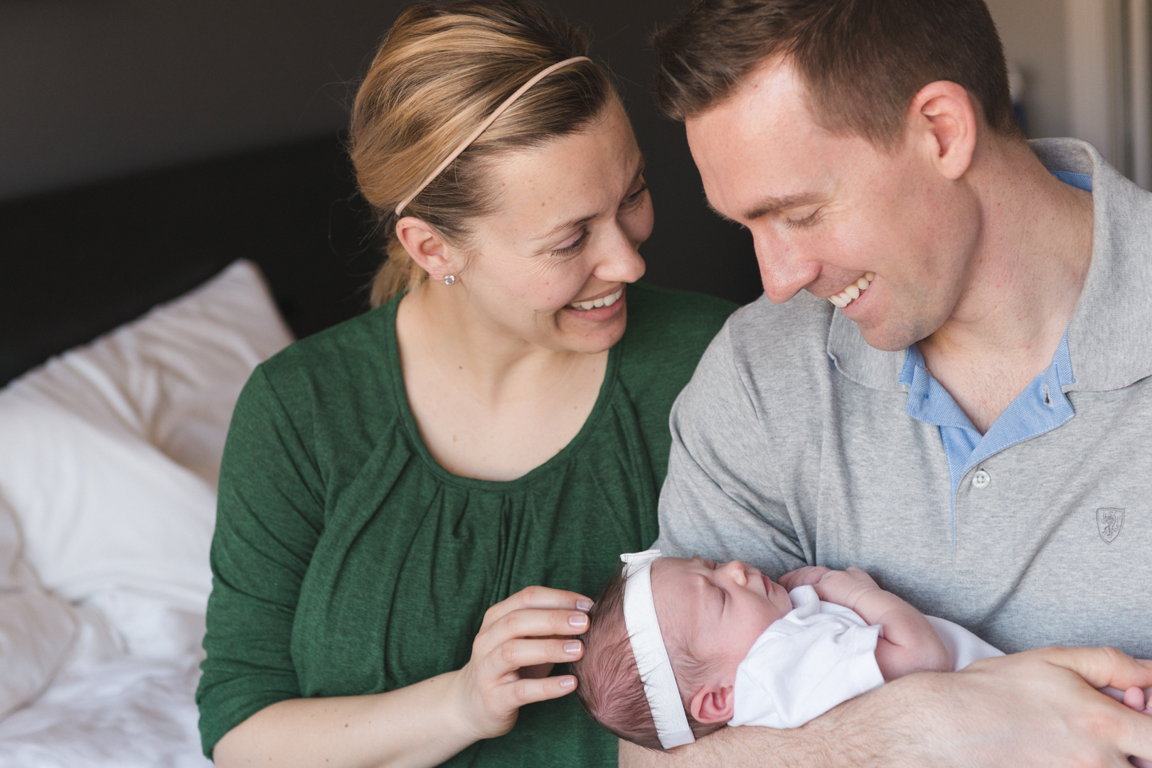 parents smiliing at their baby girl