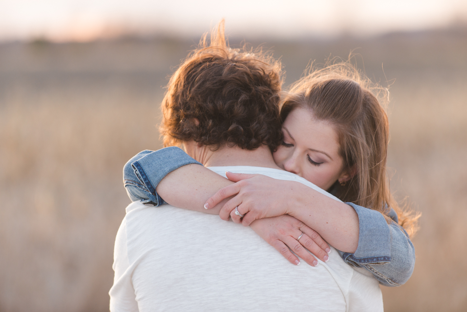 Engaged couple hugging at sunset in Ottawa