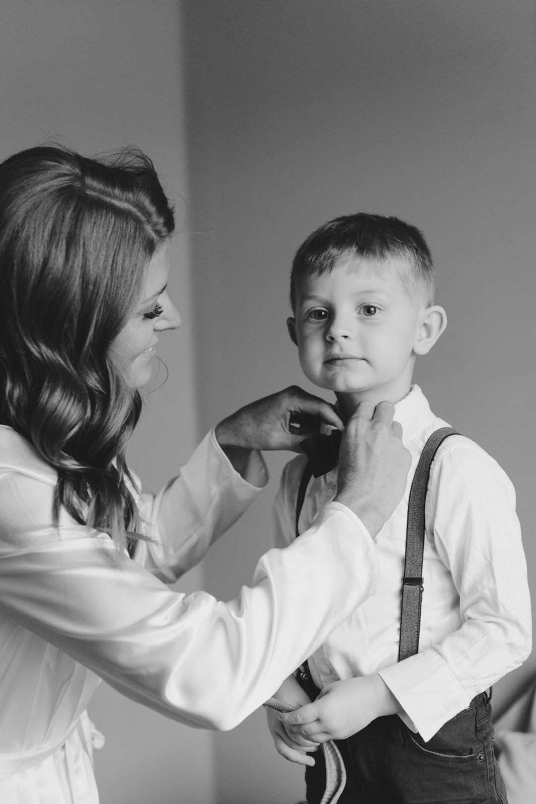 bride fixing her son's bow tie