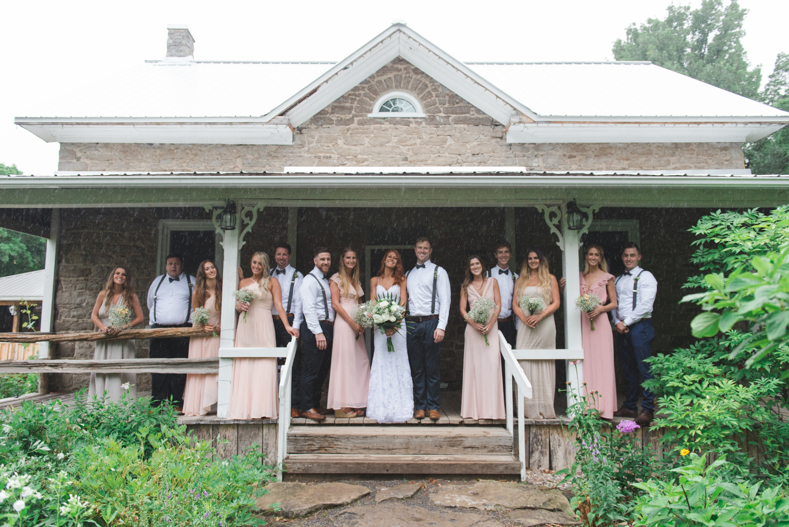 wedding party on the steps of old farm house