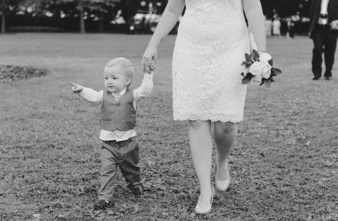 bride and her son walking in the grass