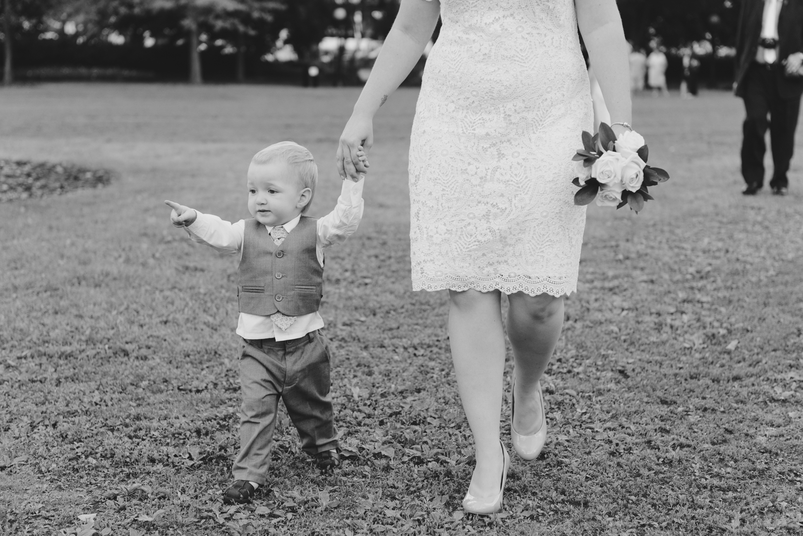 bride and her son walking in the grass