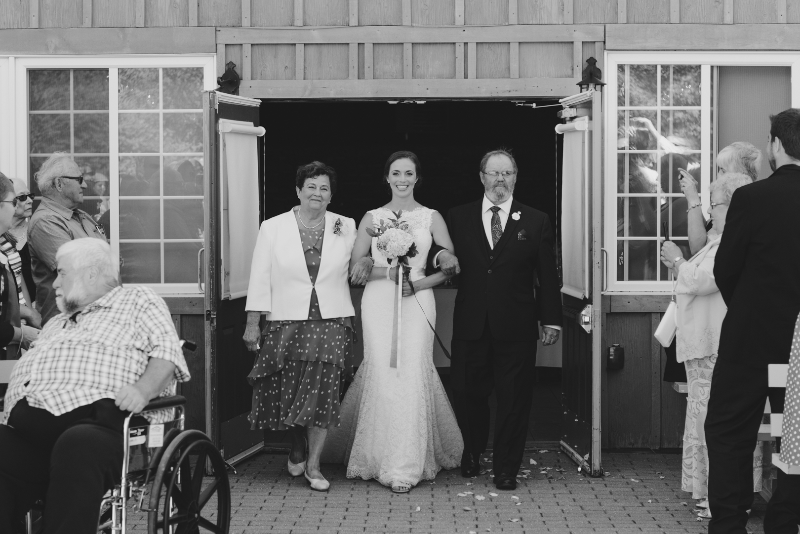 bride and her parents walking down the aisle at the Strathmere Garden House