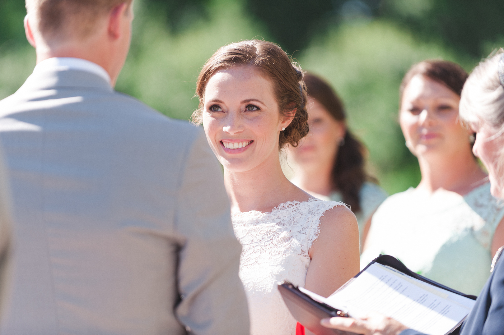 Bride smiling at her groom during ceremony