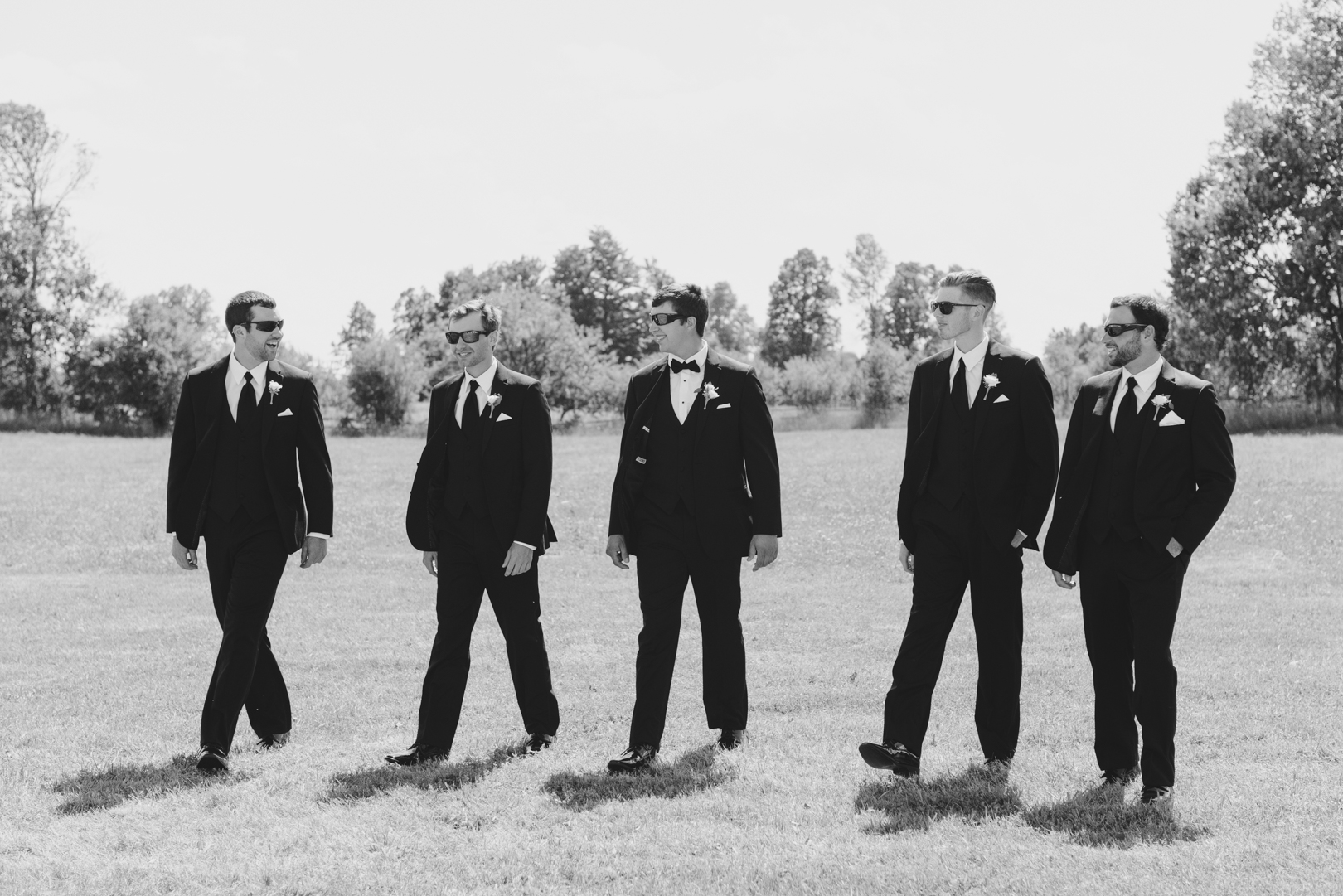 groomsmen walking in field