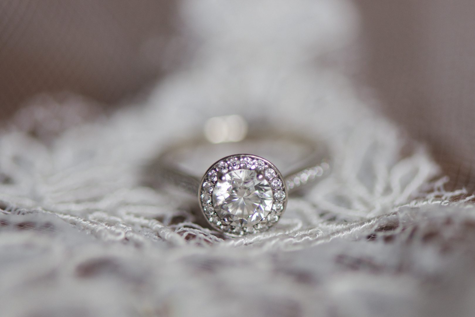 bride's engagement ring on lace cathedral veil