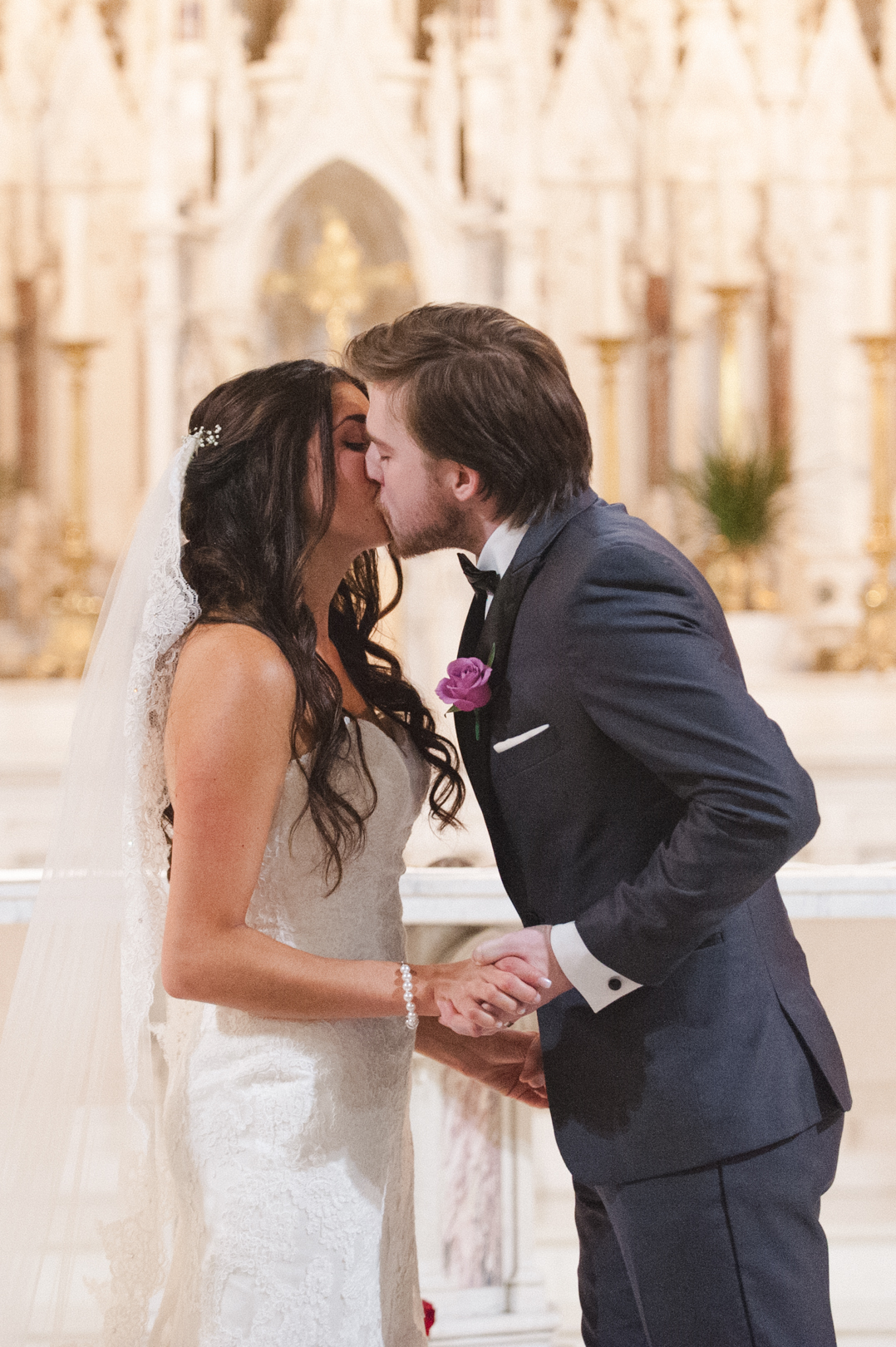 bride and groom first kiss at basilica