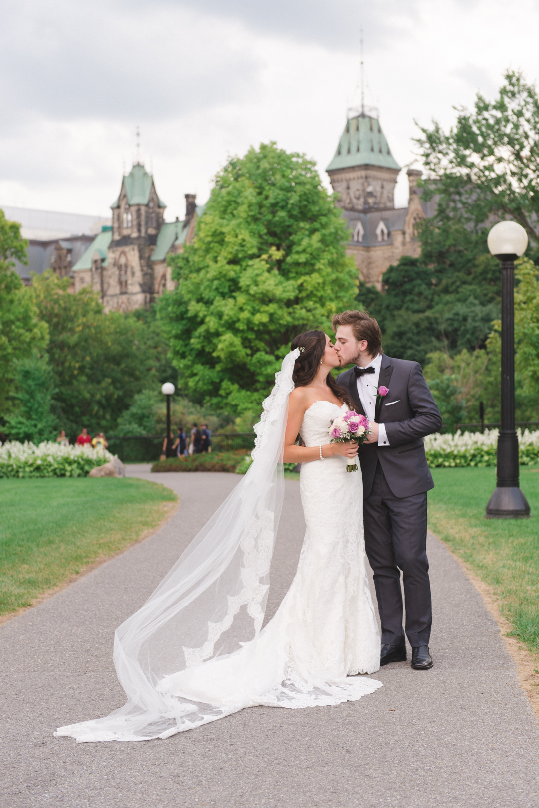 bride and groom kissing at majors hill park overlooking the parliament buildings
