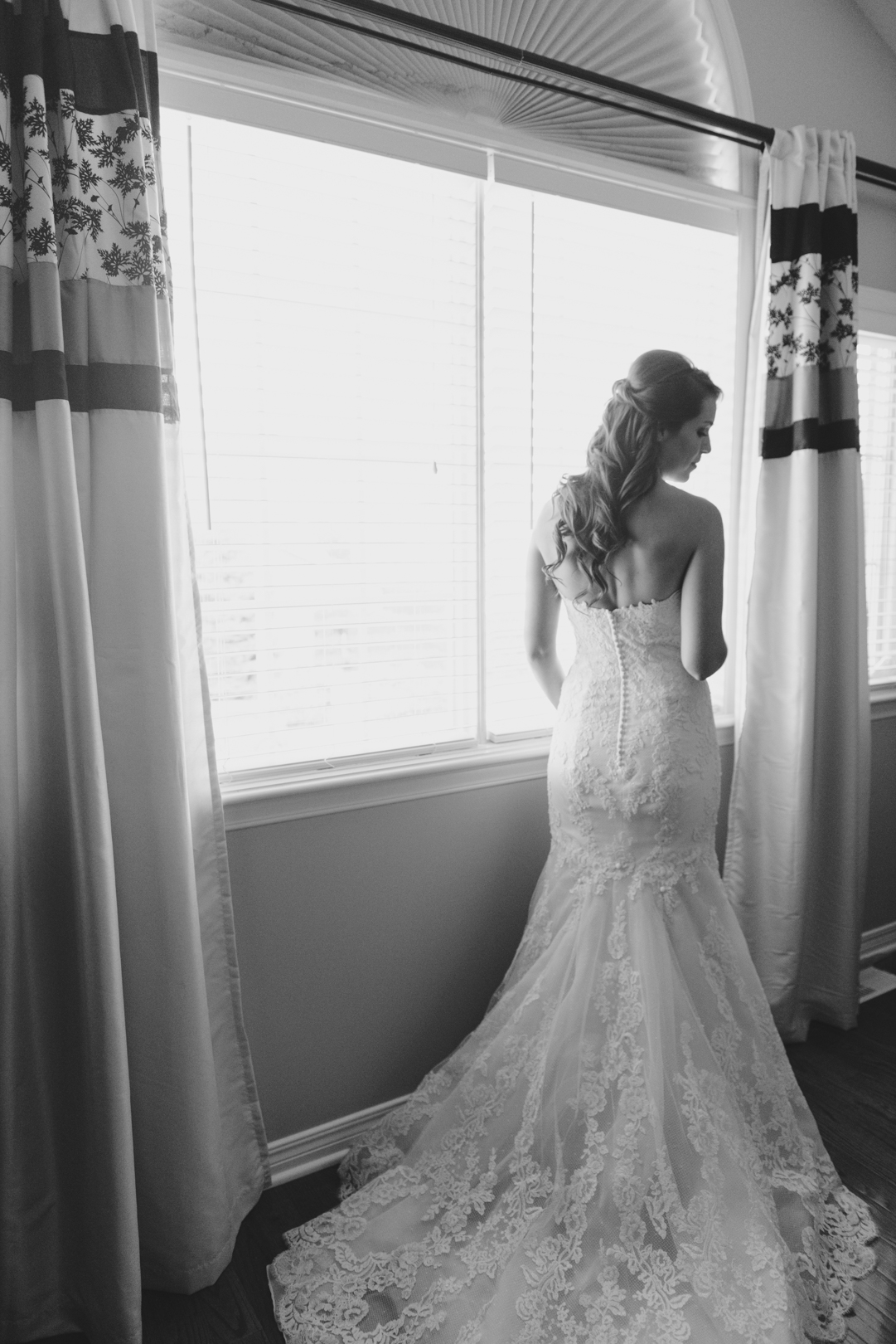 Silhouette of bride in the window getting ready