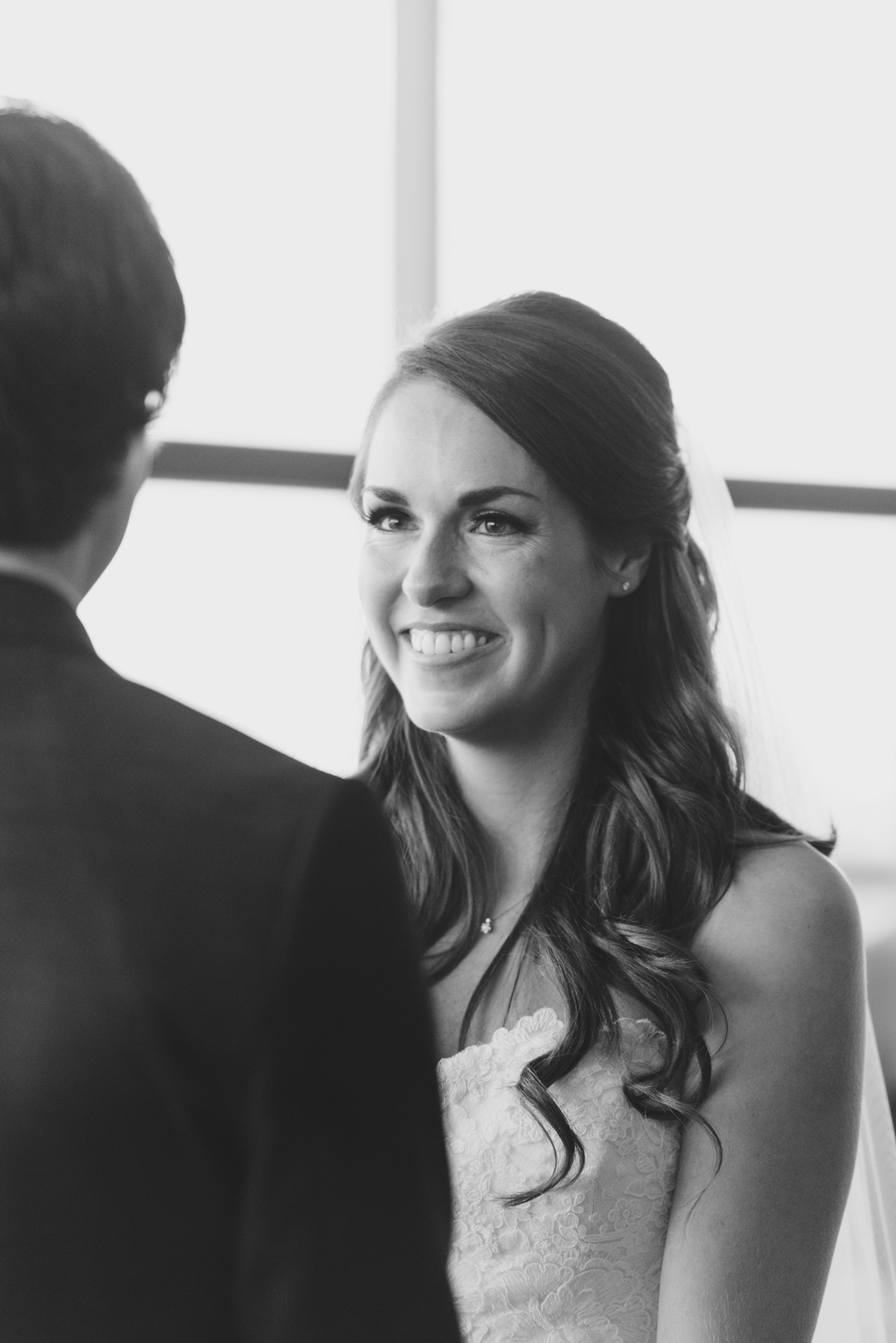bride smiling at groom during ceremony