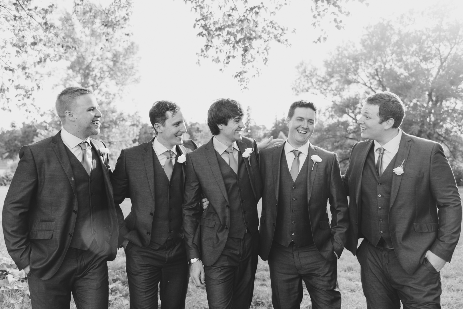 groom and groomsmen laughing at the arboretum in ottawa