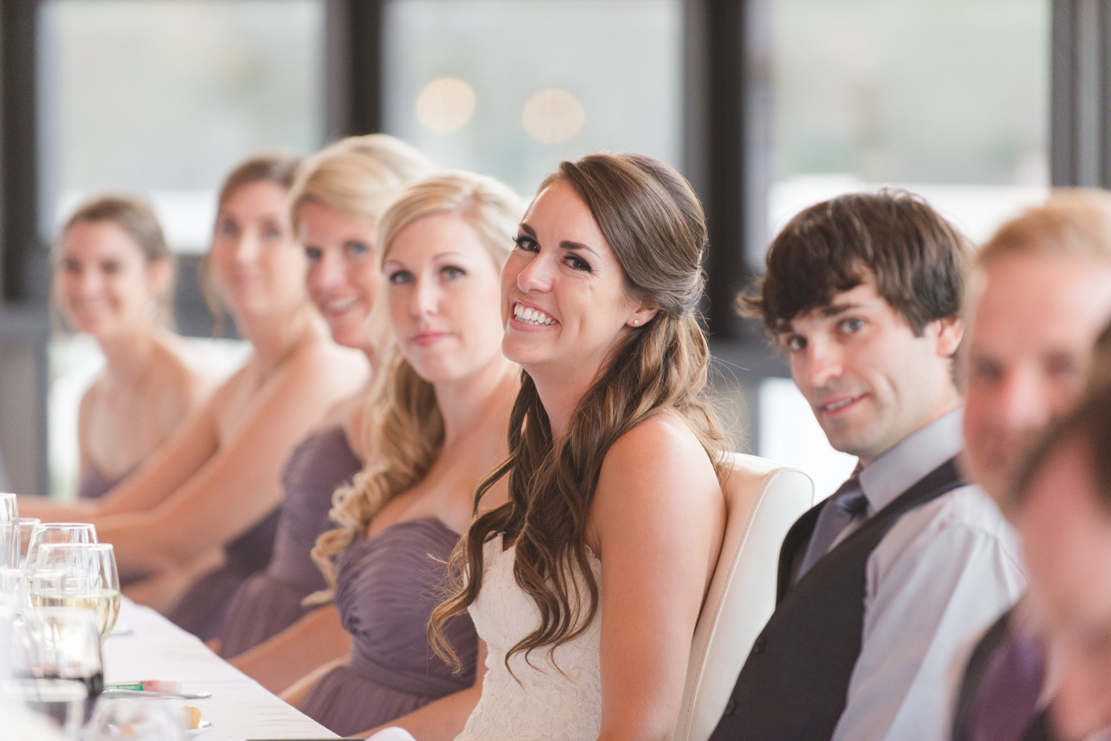 bride laughing during speech at reception