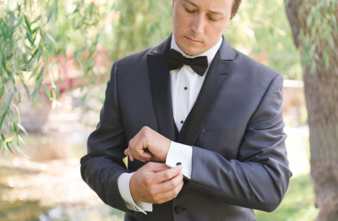 Groom adjusting his cufflinks