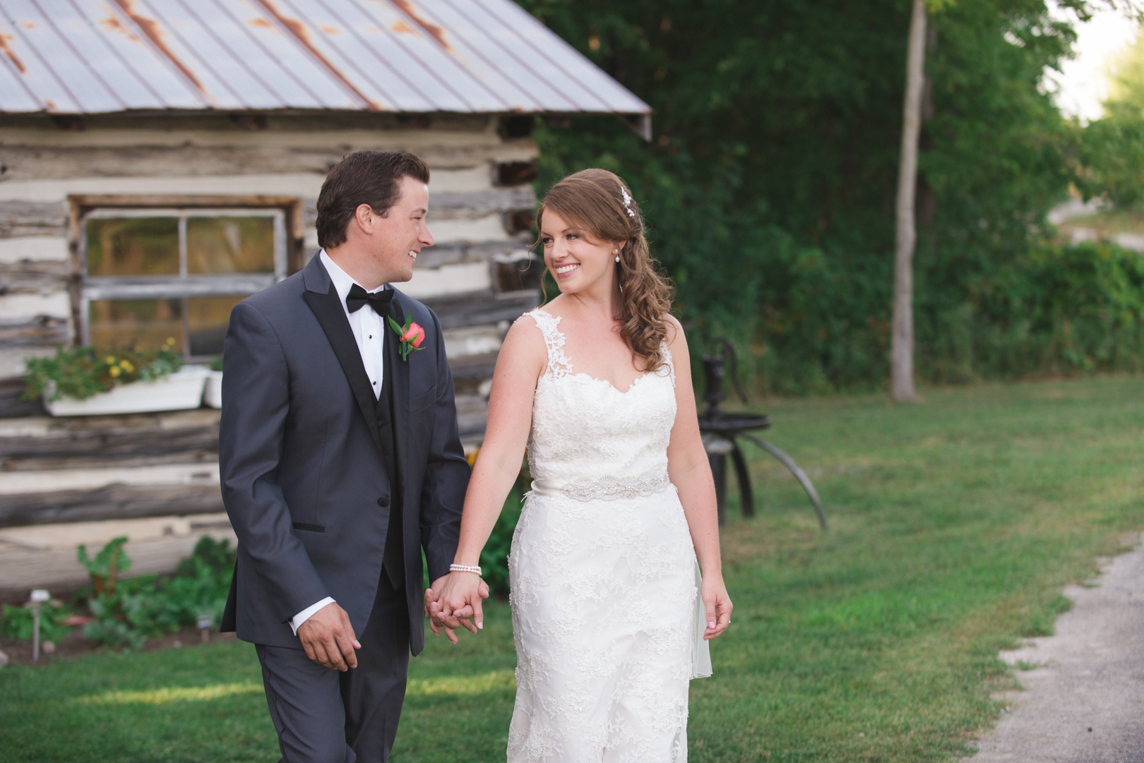 bride and groom holding hands in front of temples sugar shack