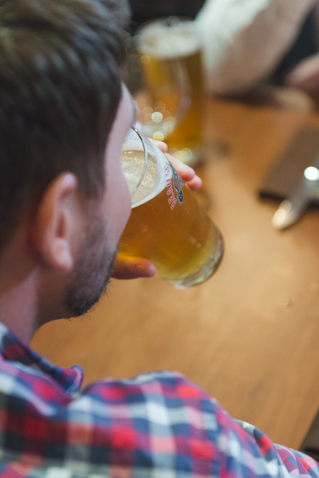 groom and groomsmen drinking beer at hotel bar