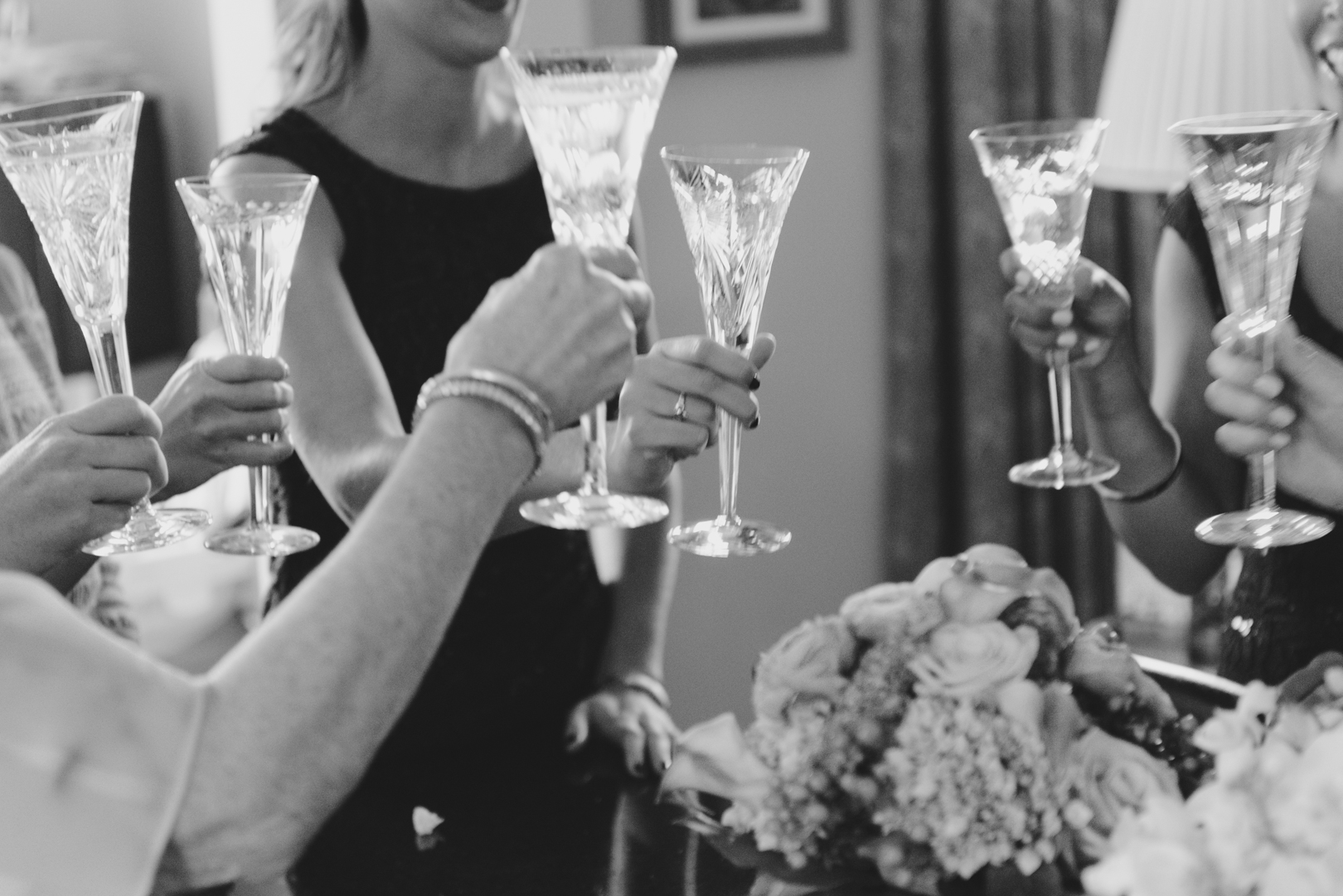 bride and bridesmaids cheersing with champagne