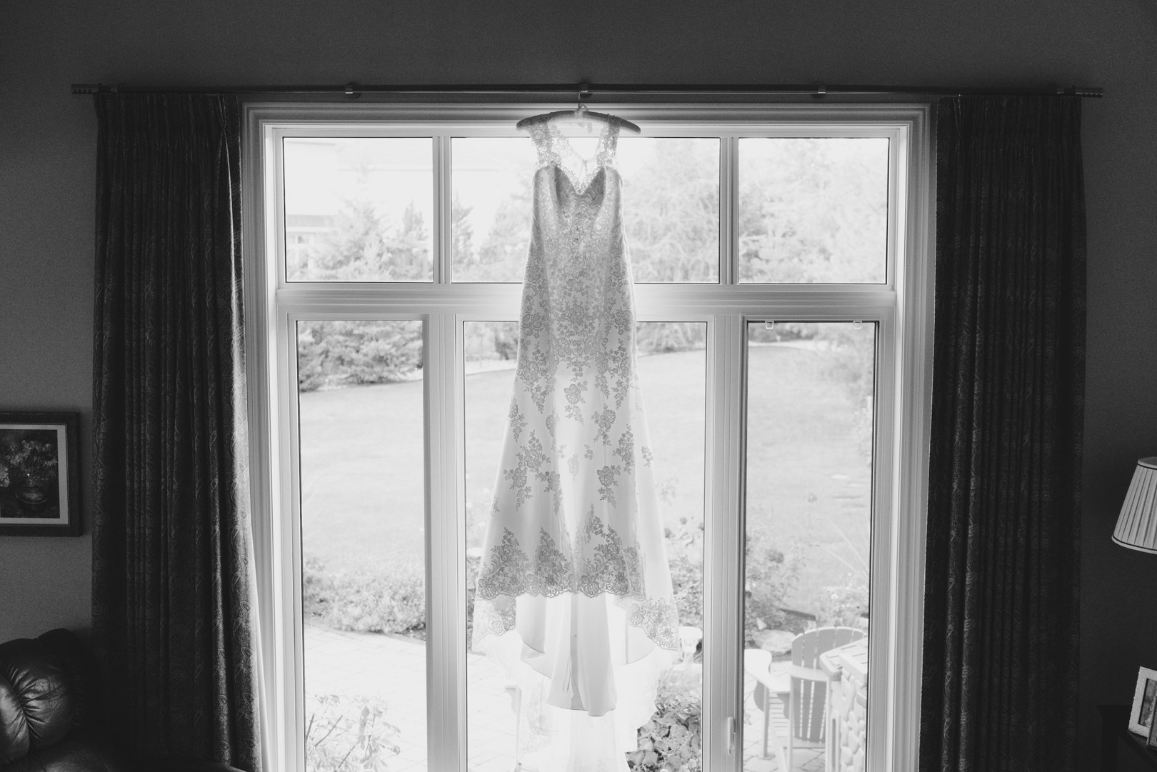 with love wedding gown hanging in window