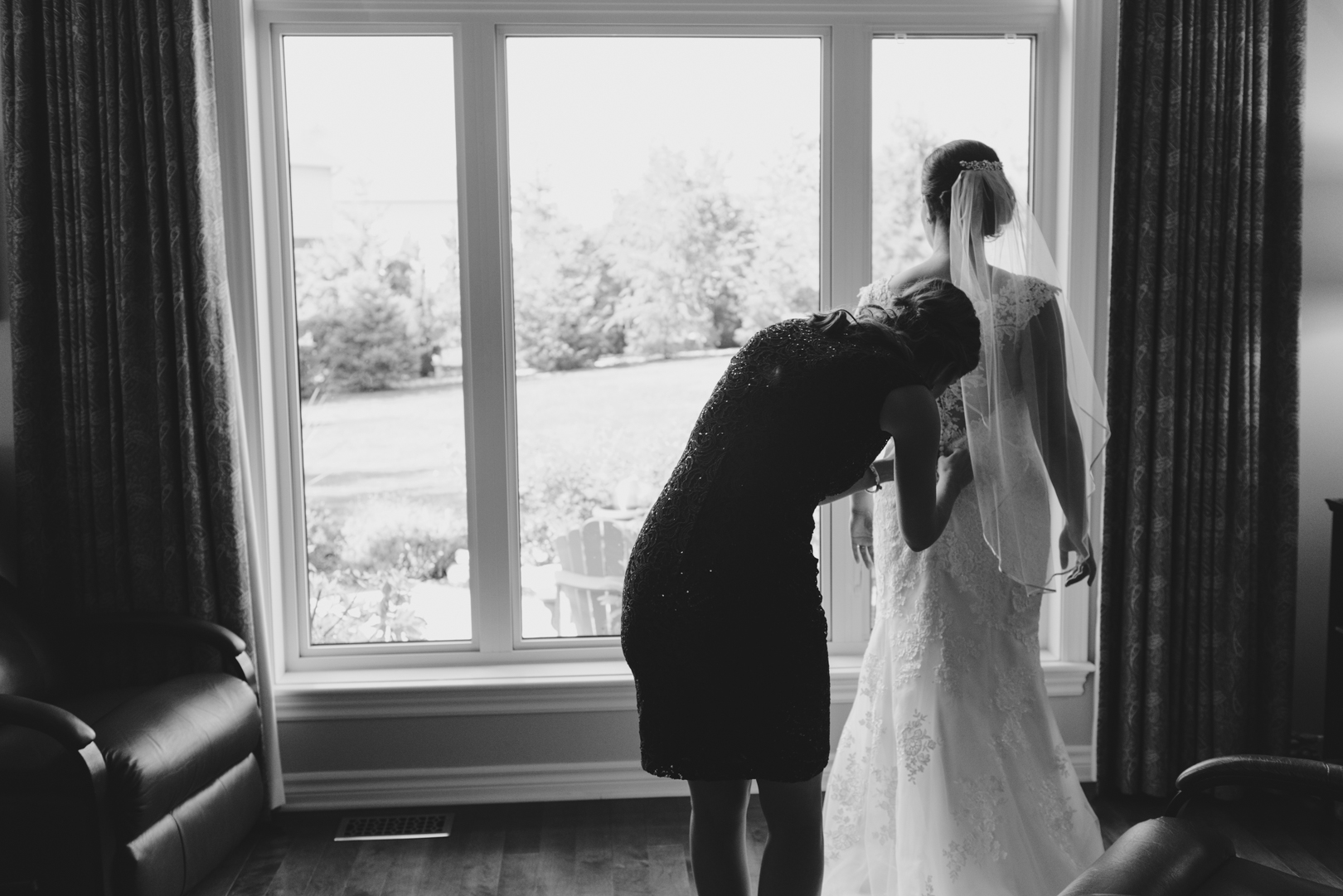 bride putting on wedding dress