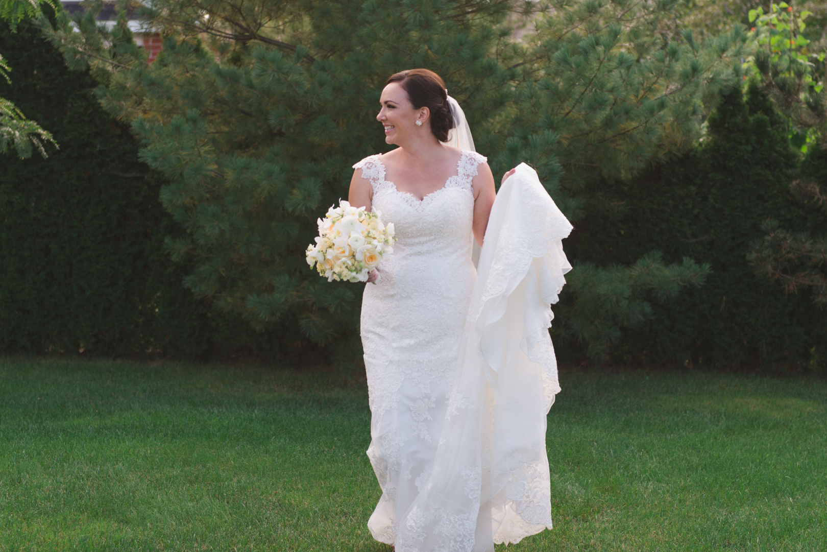 bride walking in the grass barefoot