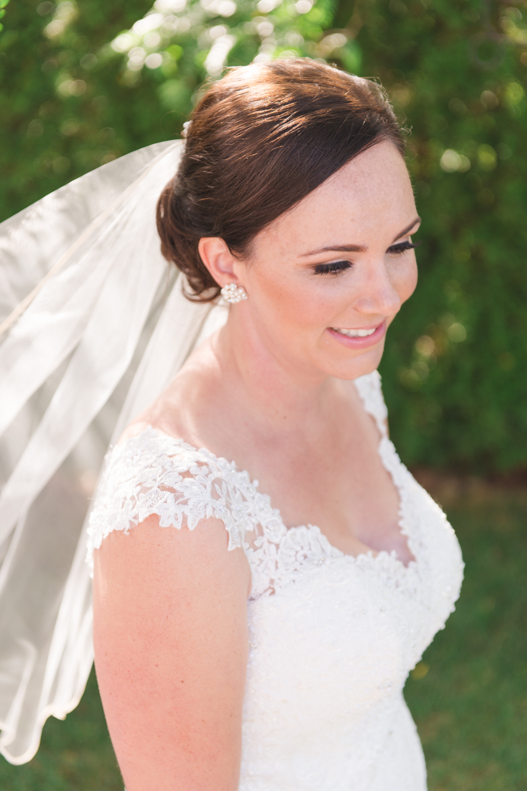 bride among the trees with veil blowing in the wind