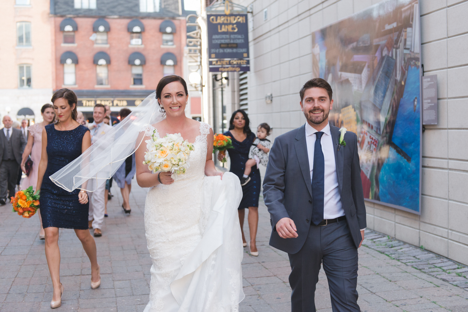 bride and groom walking in the byward market