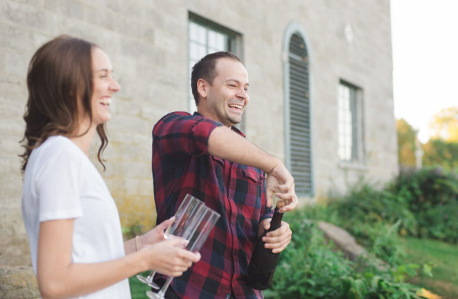 husband to be popping a bottle of champagne at pinhey's point