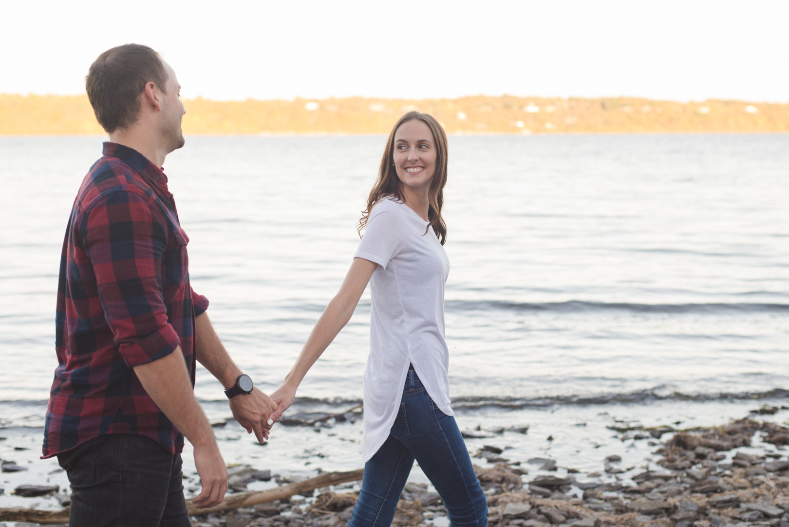 engagement couple walking along the ottawa river