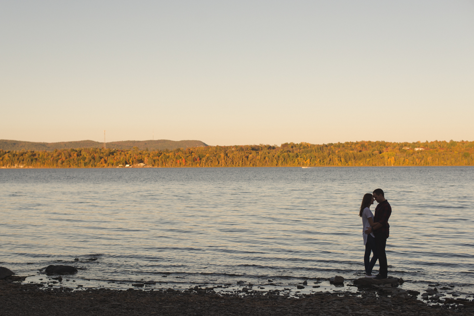 silhouette of couple with the sun setting over the ottawa river