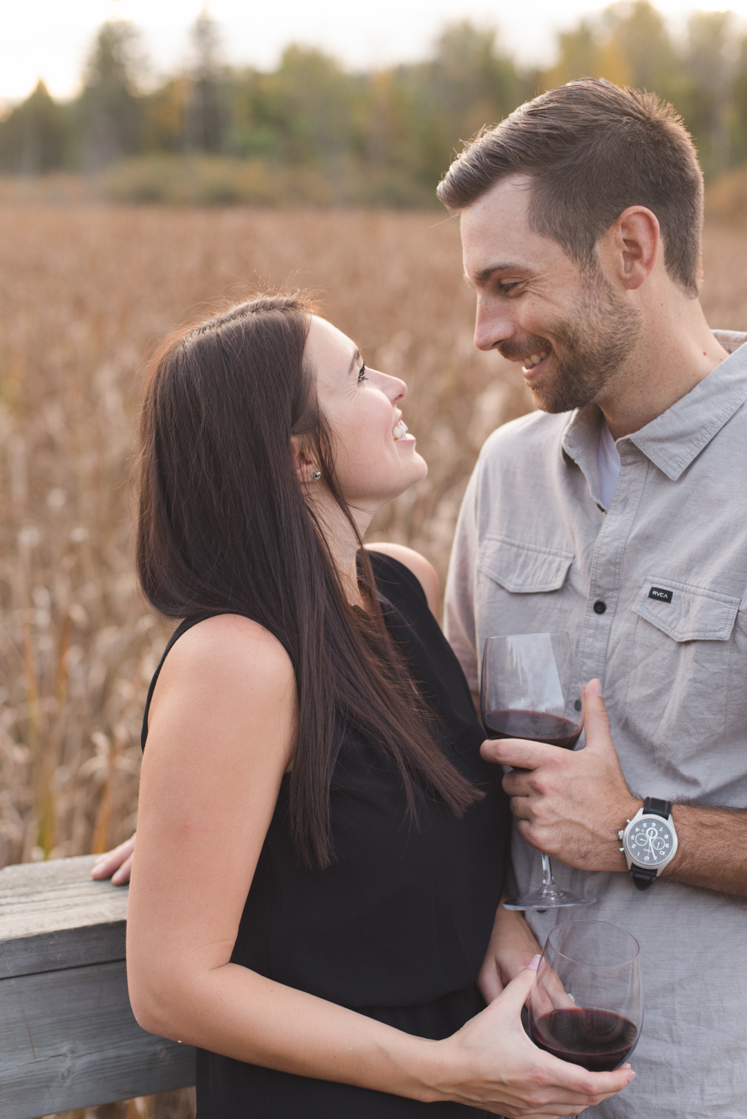 engaged couple enjoying a glass of wine in the wilderness