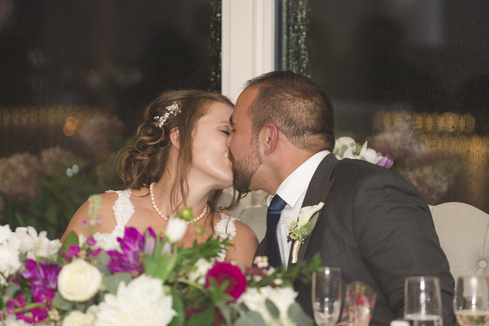 bride and groom kissing at le belvedere wedding reception