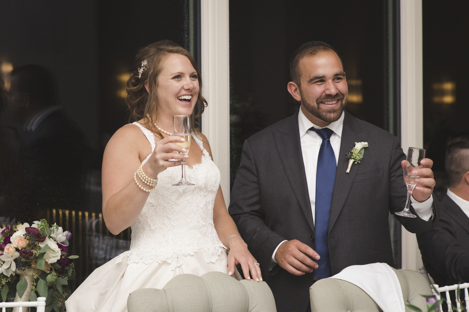 bride and groom cheers at belvedere wedding reception