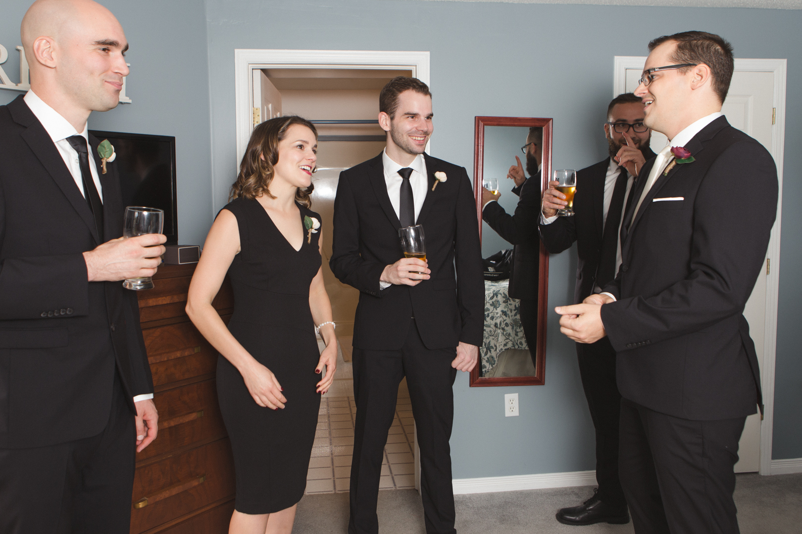 groomsmen drinking beer while getting ready