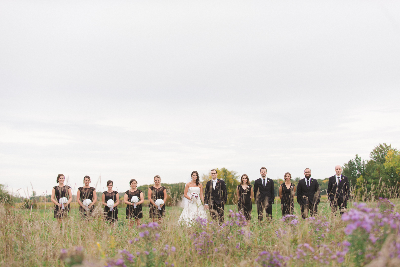 wedding party in black among the tall lavender grass